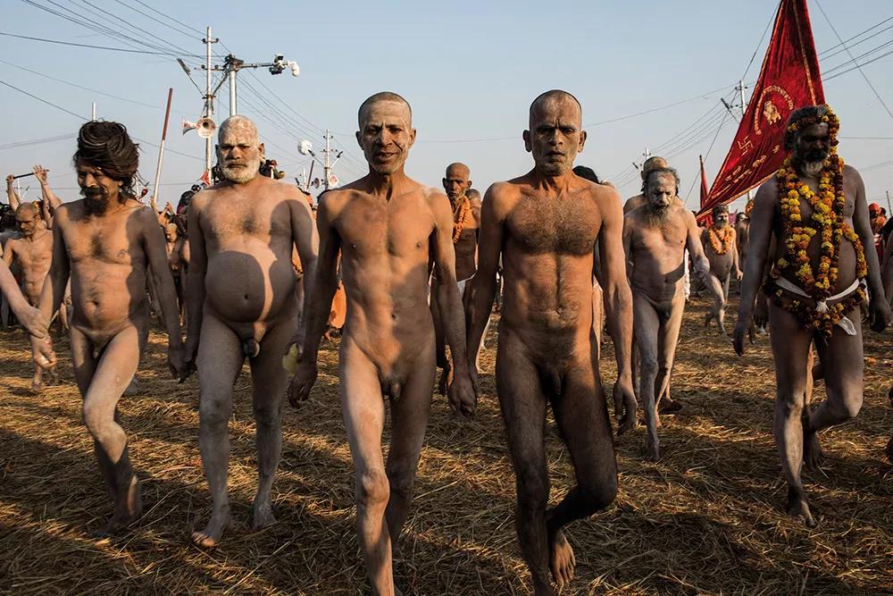Naga sadhus caminan hacia el río Ganges para un baño real.